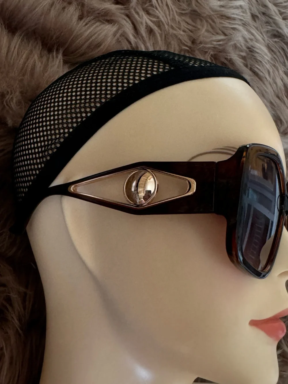 Futuristic sunglasses with large button detail on the sides
